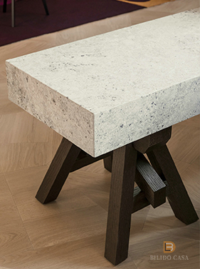 Custom furniture table with textured stone-like top and dark wooden base, showcasing meticulous craftsmanship